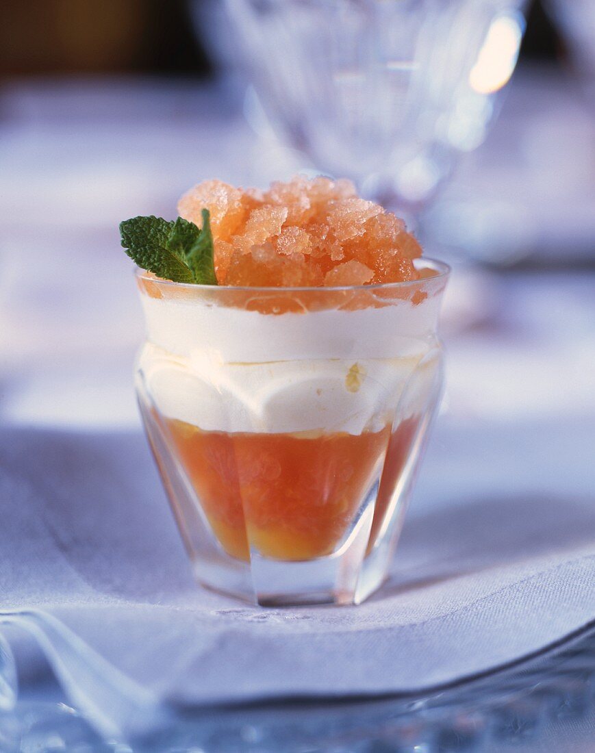 Citrus fruit with cream and grapefruit granita in dessert glass