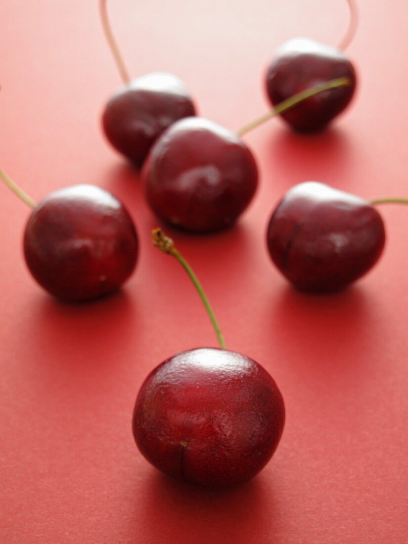 Cherries on a red surface