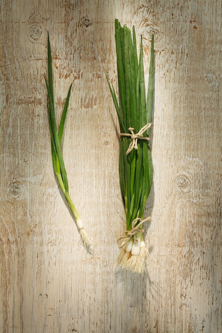 Spring onions on a wooden surface