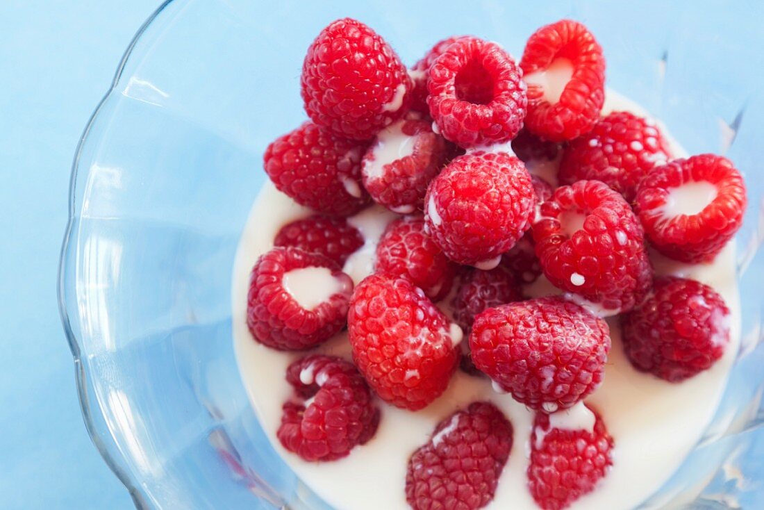 Raspberries with Milk in a Glass Bowl; From Above