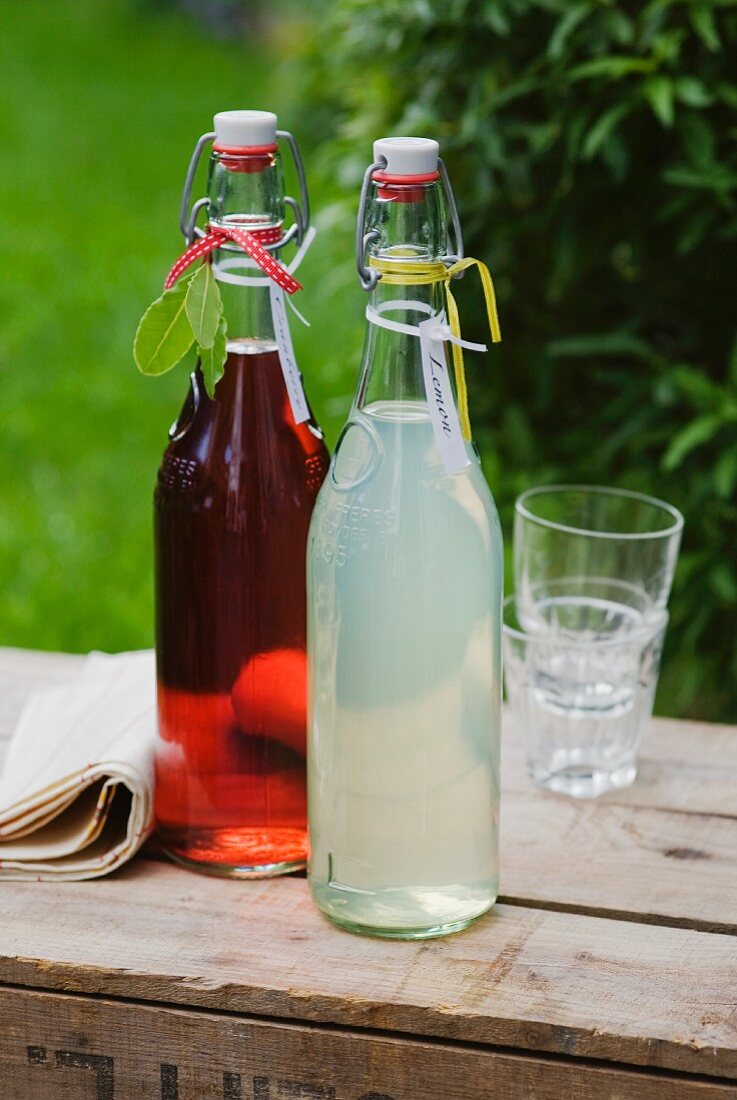 Home-made lemonade and cranberry juice in swing-top bottles
