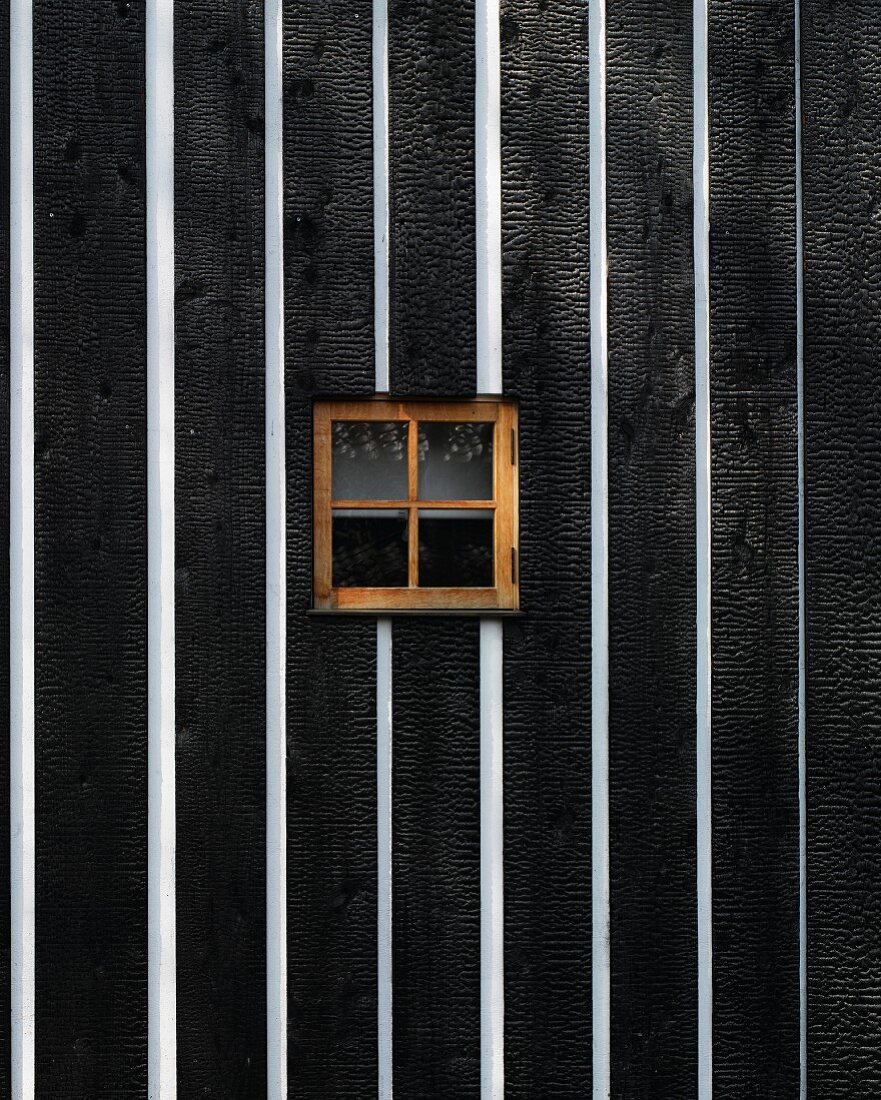 Black and white wooden wall with small window