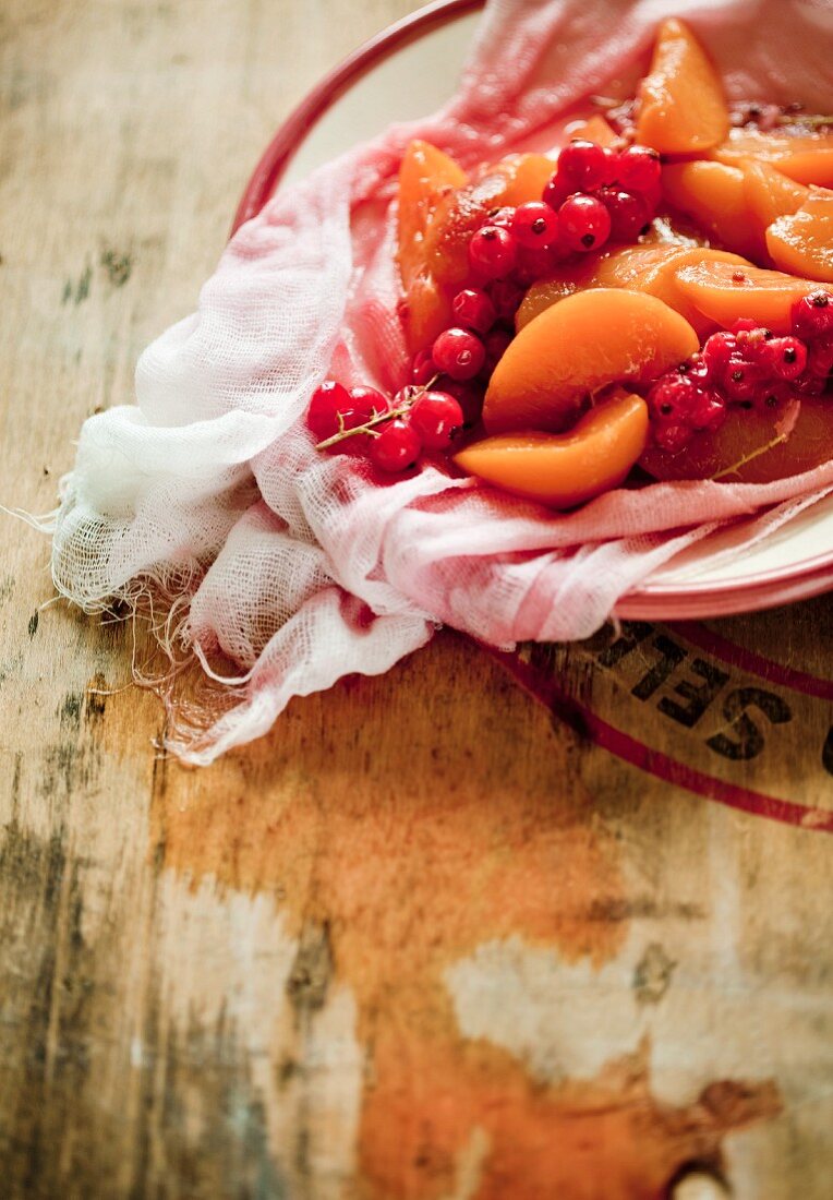 Peaches with currants on cheesecloth (for compote)