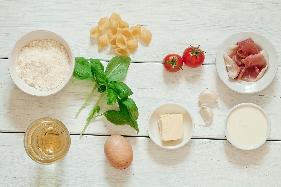 Ingredients for pasta carbonara with tomatoes and prosciutto