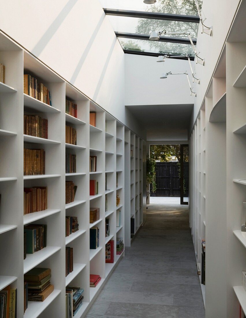 Library corridor with slanting skylight and glass door leading to courtyard
