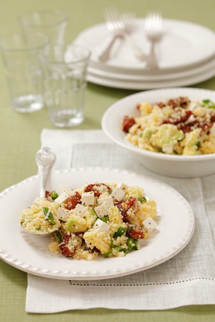 Couscous salad with dried tomatoes, avocado, spring onions and feta cheese