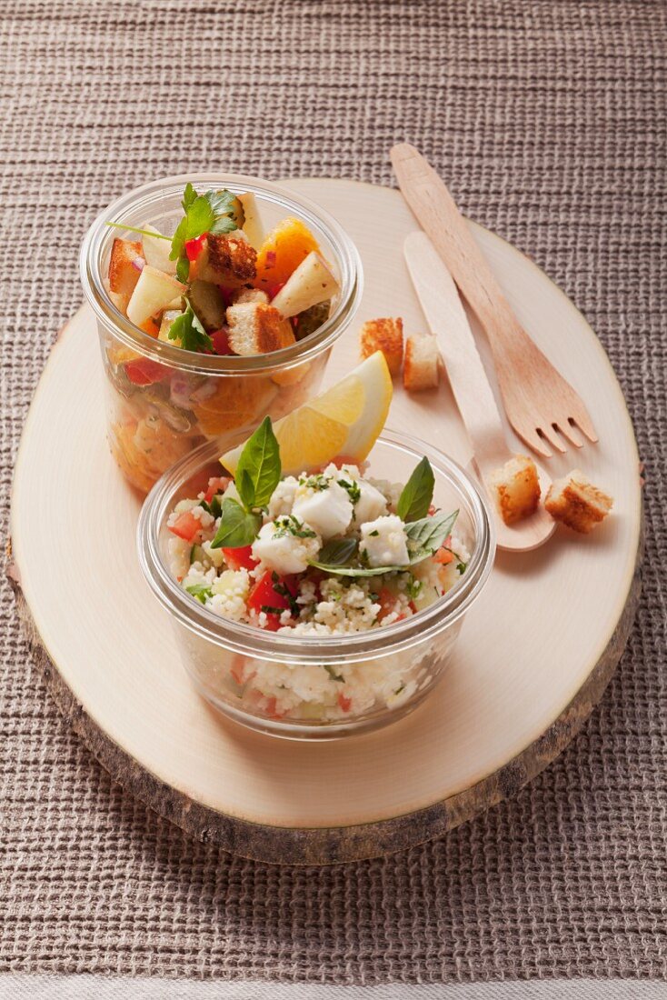 Spicy apple salad with croutons and couscous salad with mozzarella