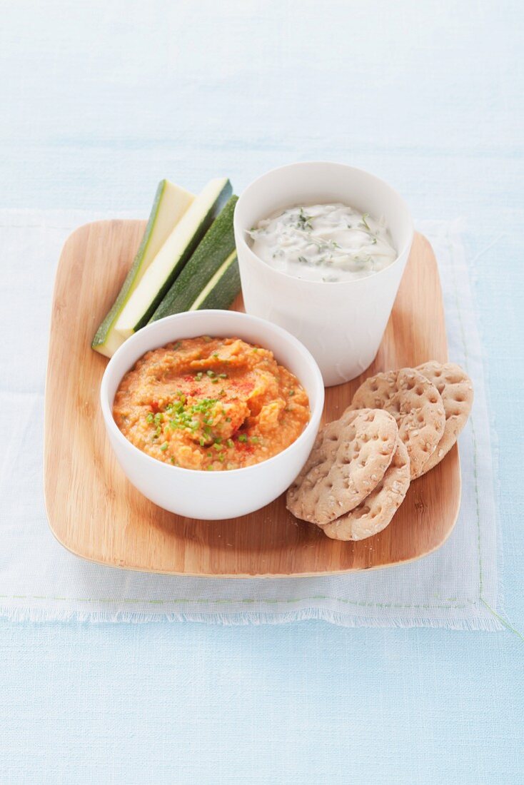 Chickpea puree with crackers and herb-cream cheese with zucchini sticks