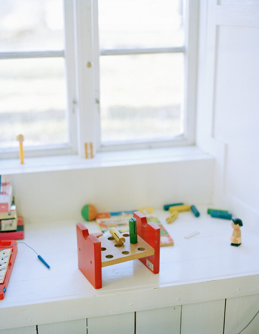 Child's toys on white windowsill