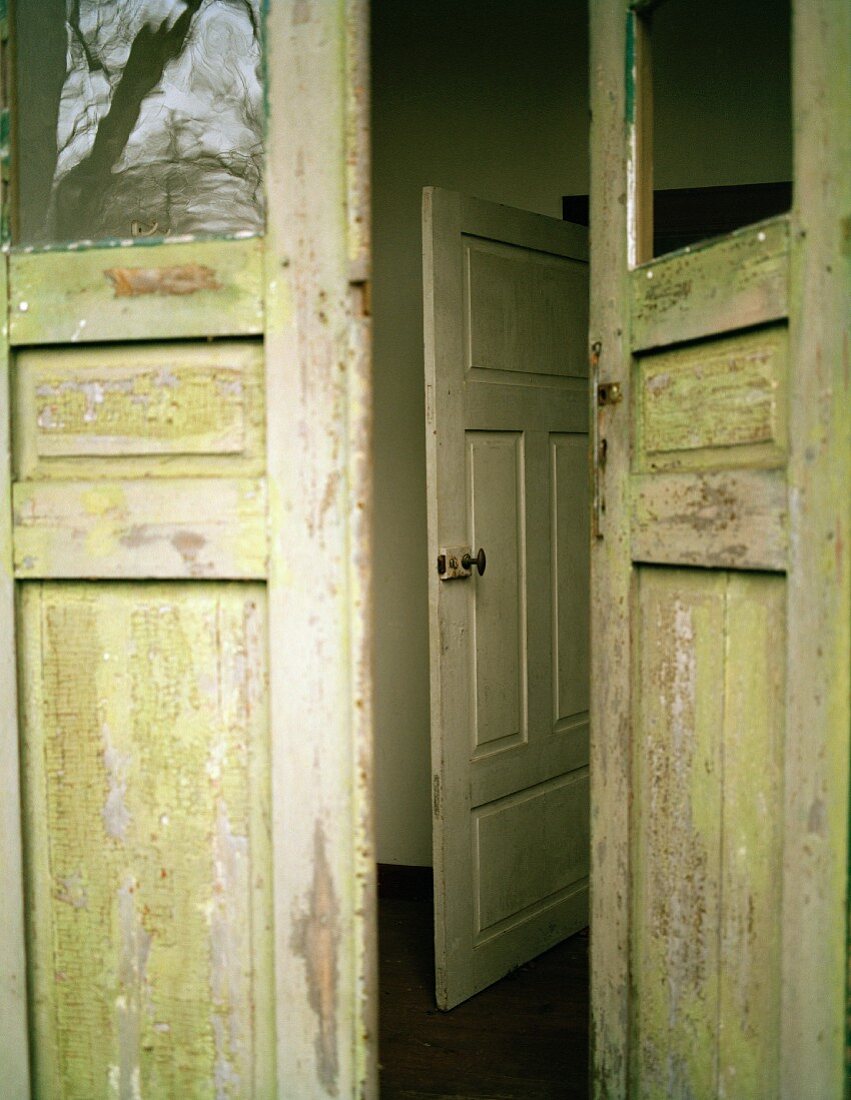 Weathered exterior door with missing pane of glass