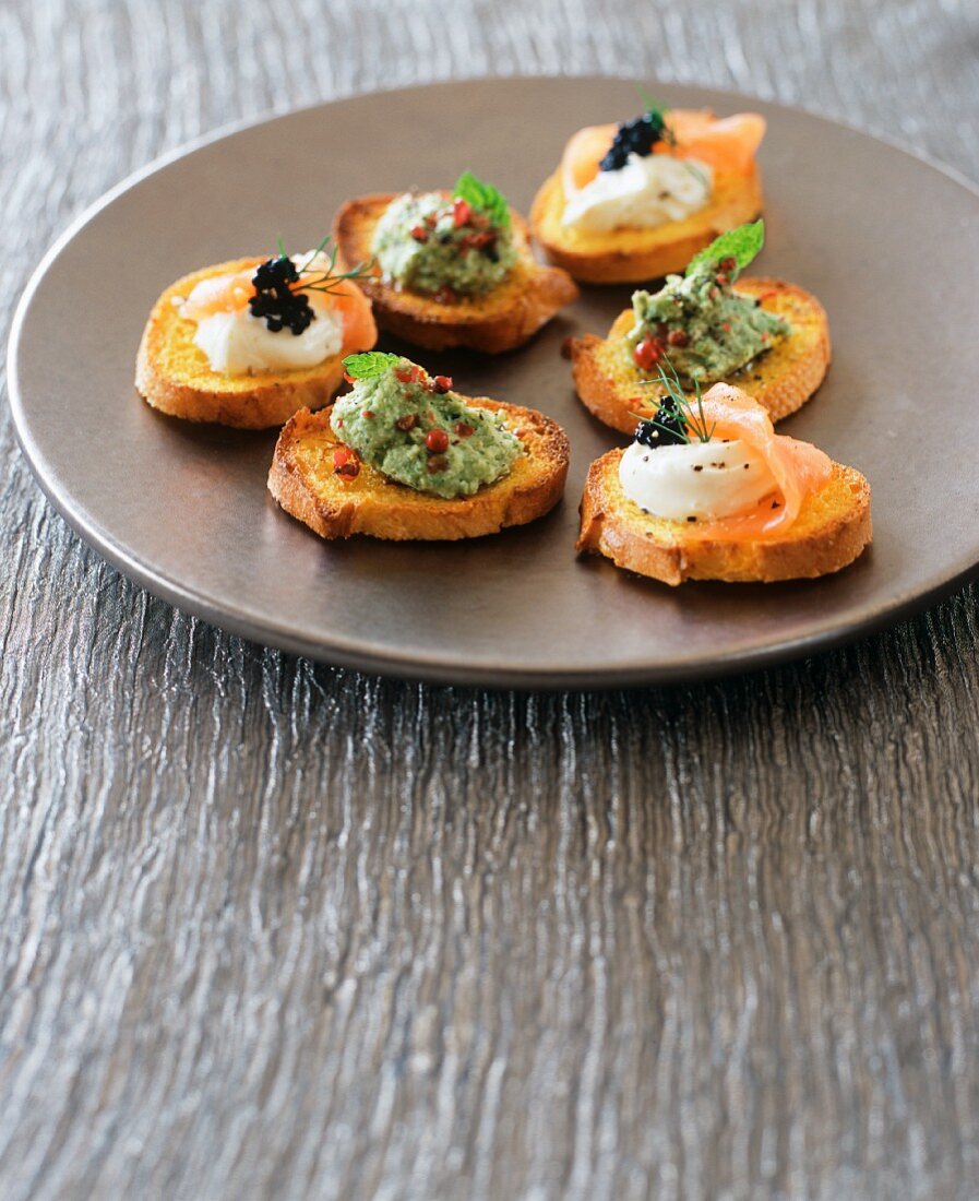 Crostini with guacamole and with cream cheese and salmon