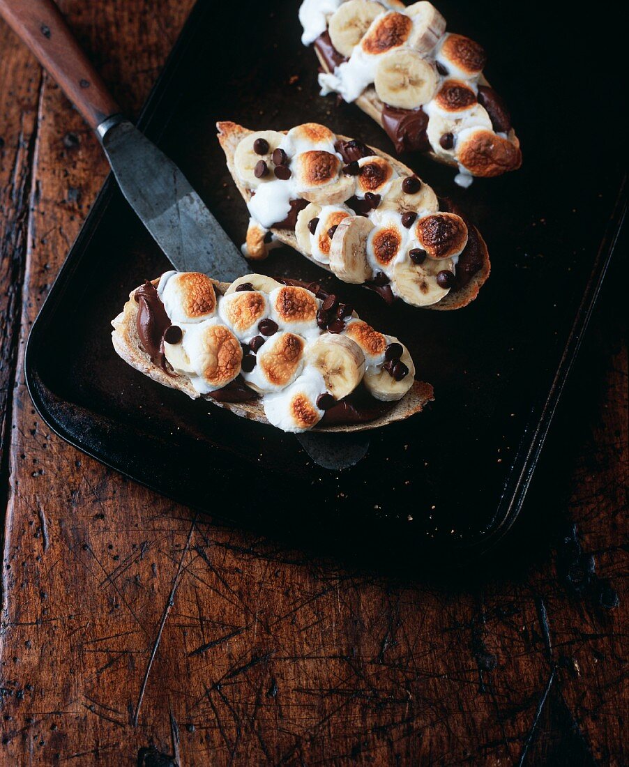 Bread topped with chocolate cream, bananas and marshmallows