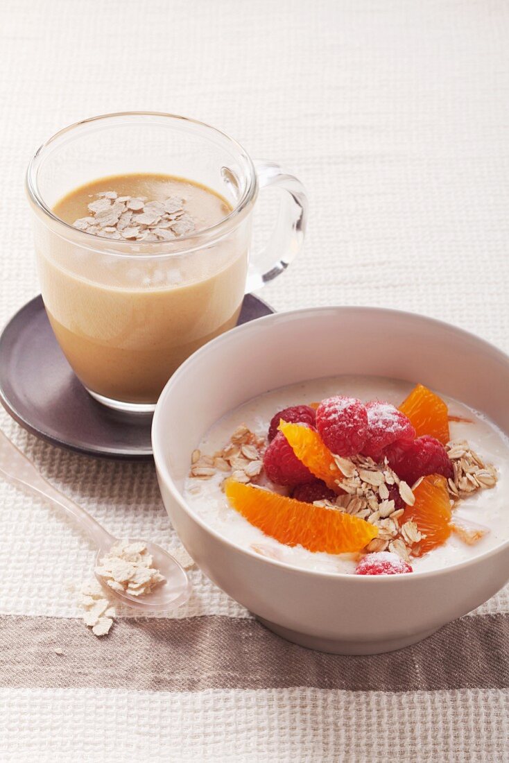 Cream cheese muesli with oranges and raspberries and sea buckthorn milk with oats