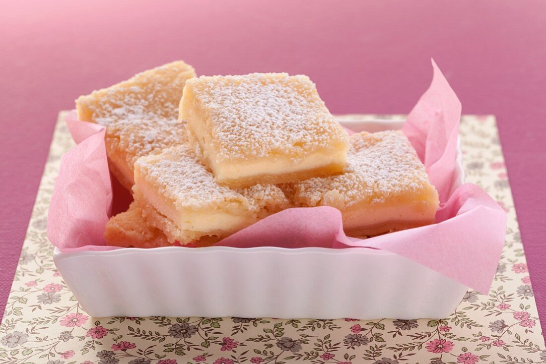 Cream cheese squares in a dish with a pink serviette