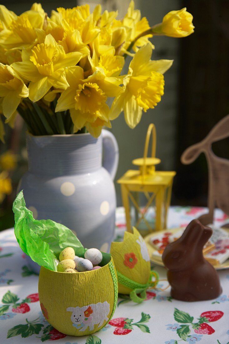 Easter sweets and daffodils on garden table