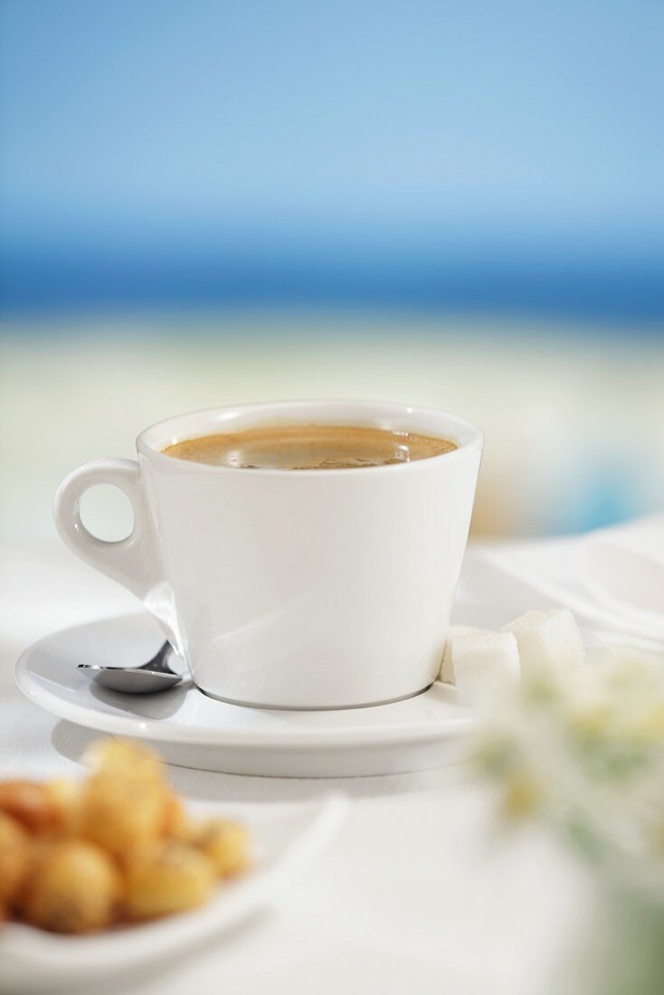 Cup of coffee, sea in background