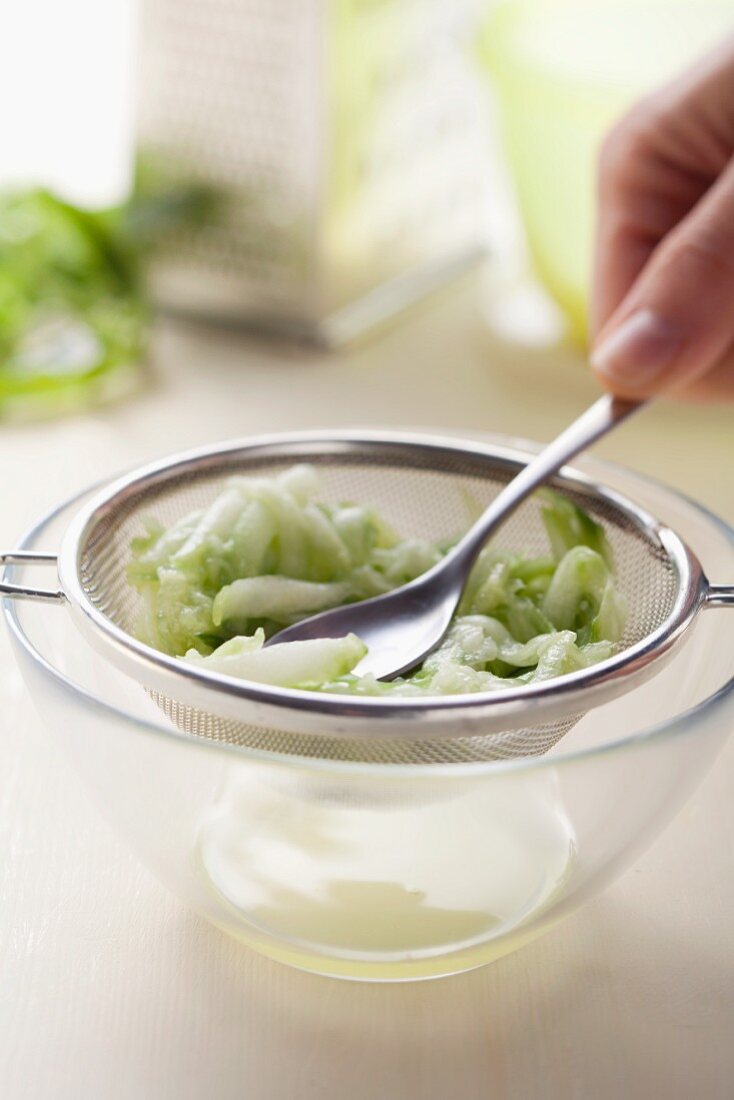 Squeezing out grated cucumber