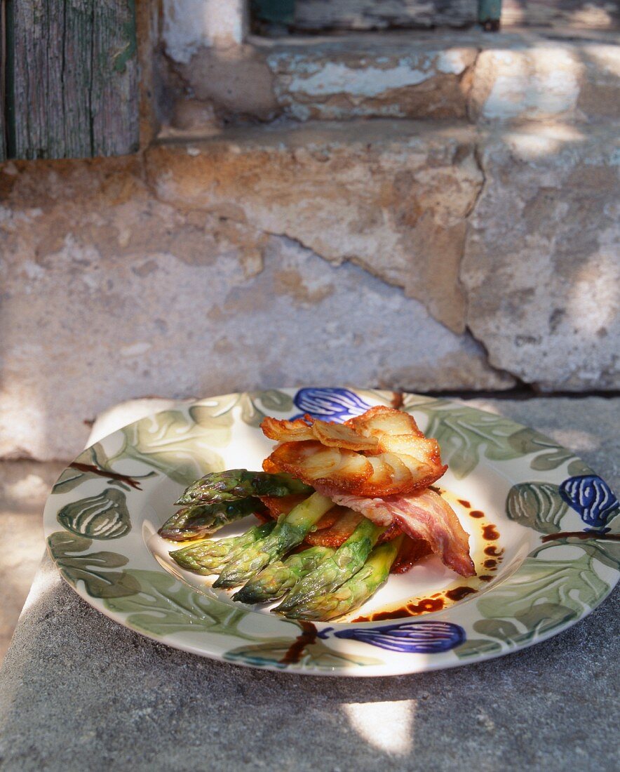 Layered potato gratin with asparagus filling and bacon