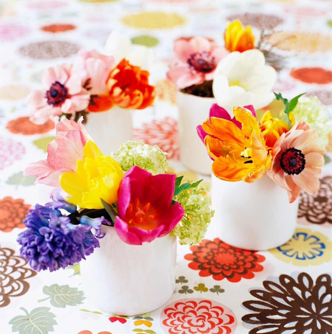 Colorful bouquets on a table cloth with a floral pattern