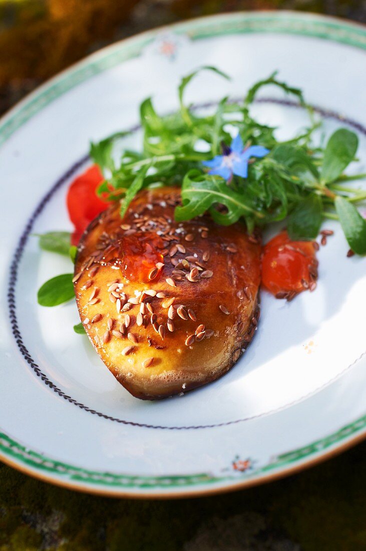 Fried goose liver with pine nuts and a side salad