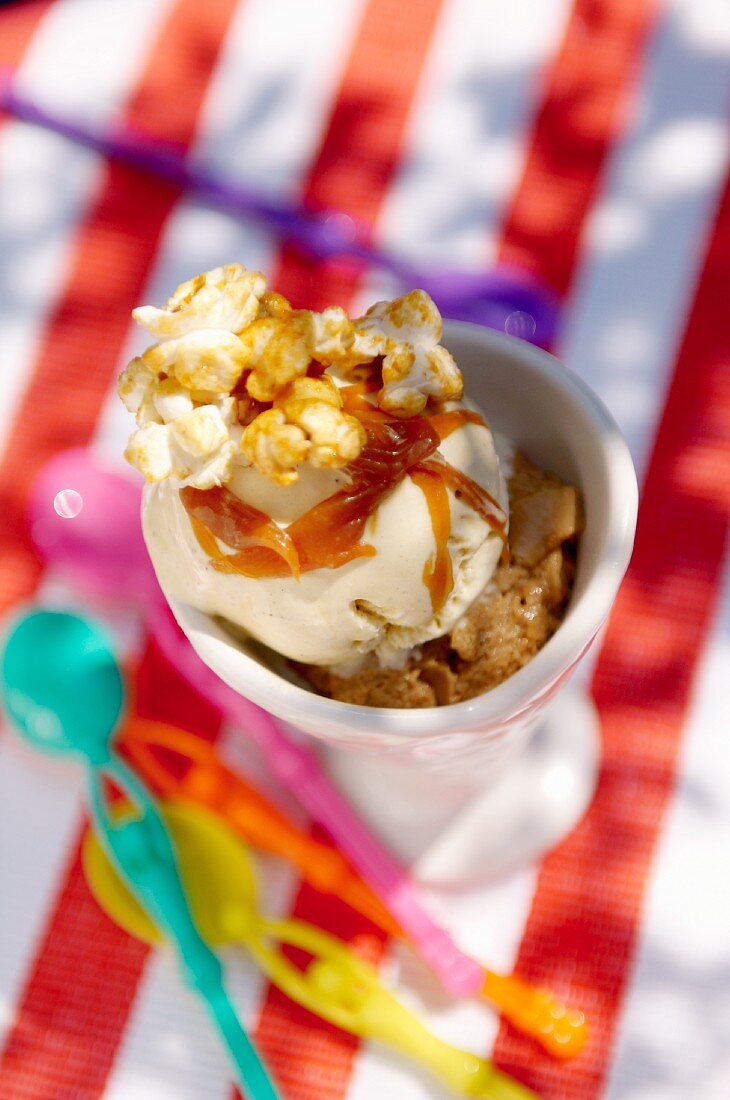 An ice cream sundae with popcorn and caramel sauce