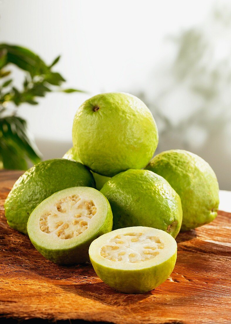 Several guavas on wooden board