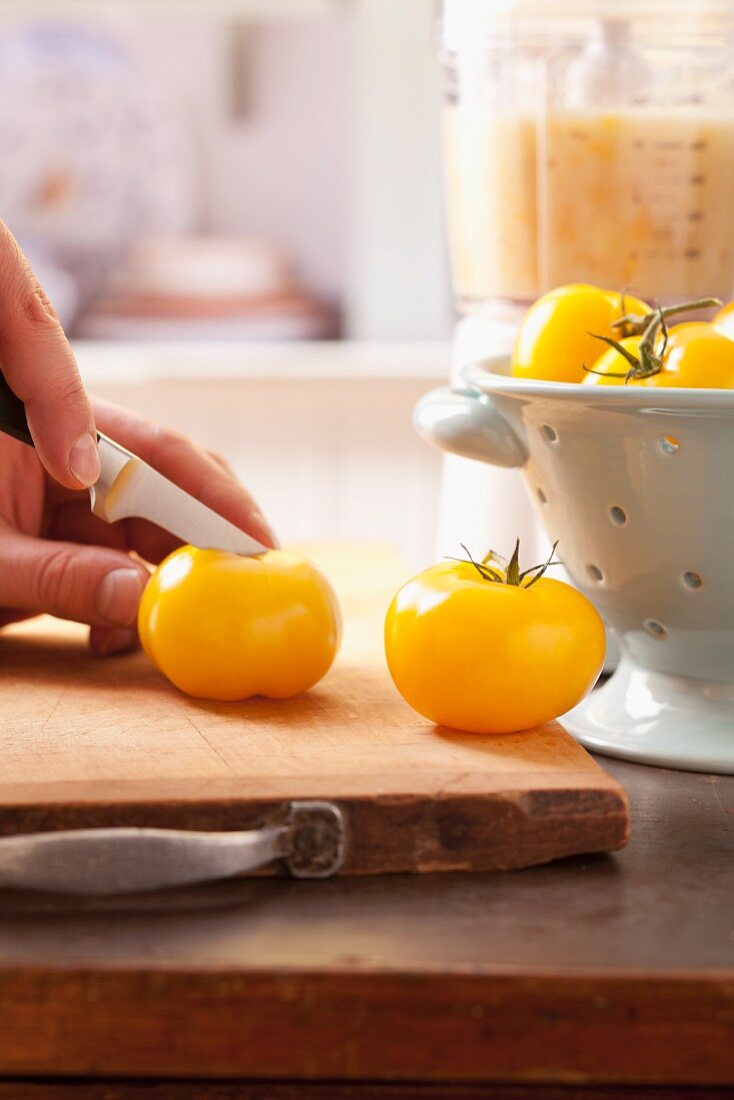 Yellow tomatoes being sliced