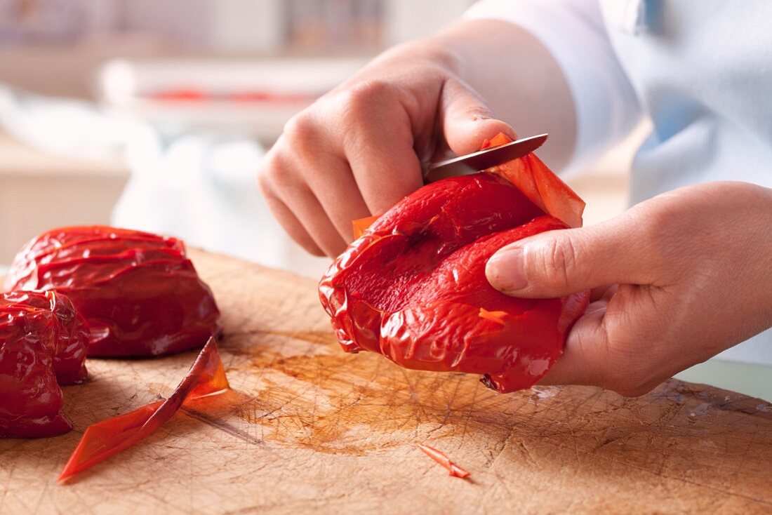 Skin being removed from roasted pepper