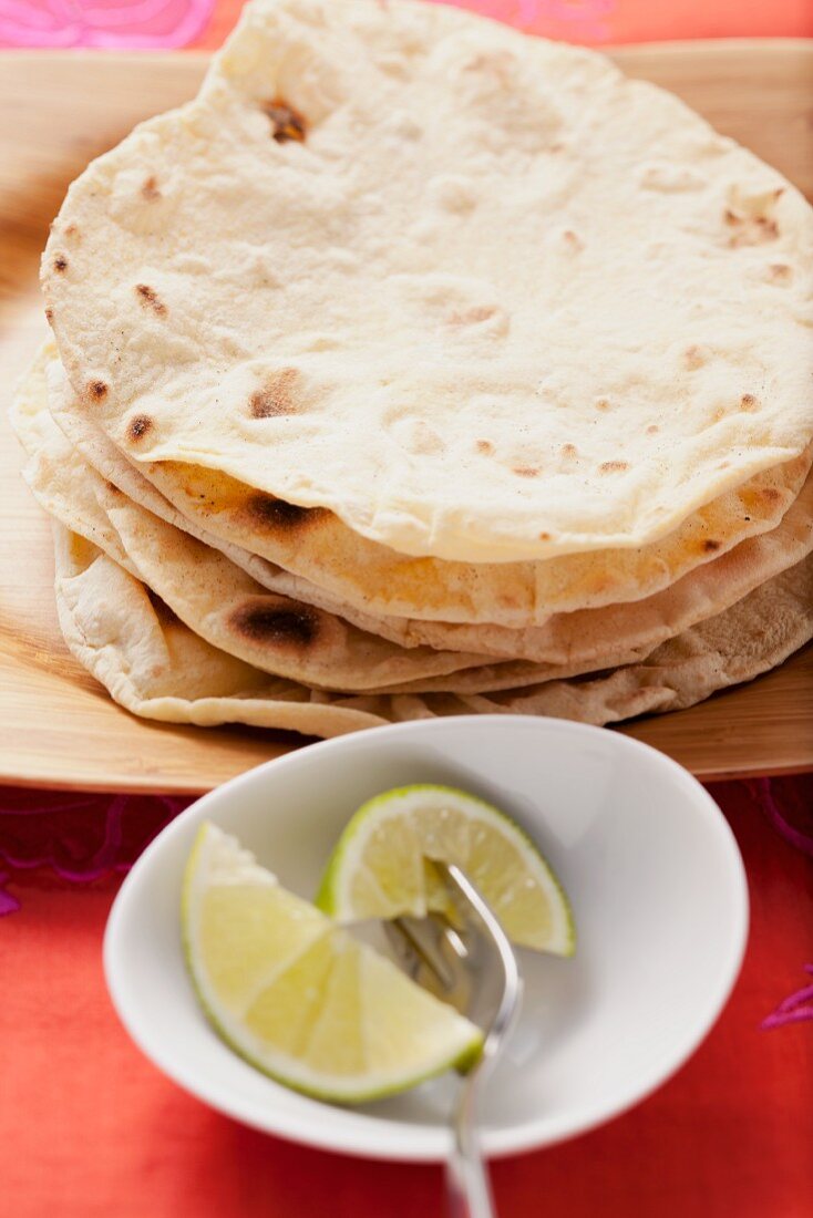 Wheat tortillas and lime wedges