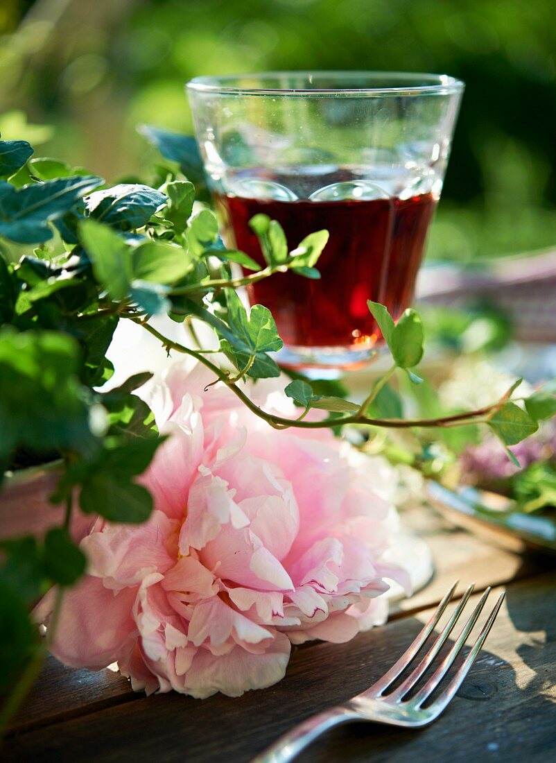 A peony and a glass of red wine