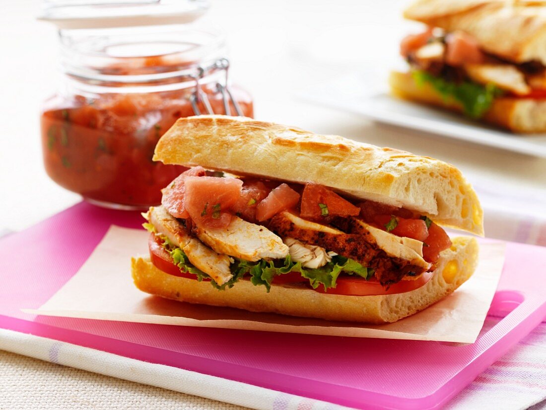 Baguette sandwich with chicken, apple and plums