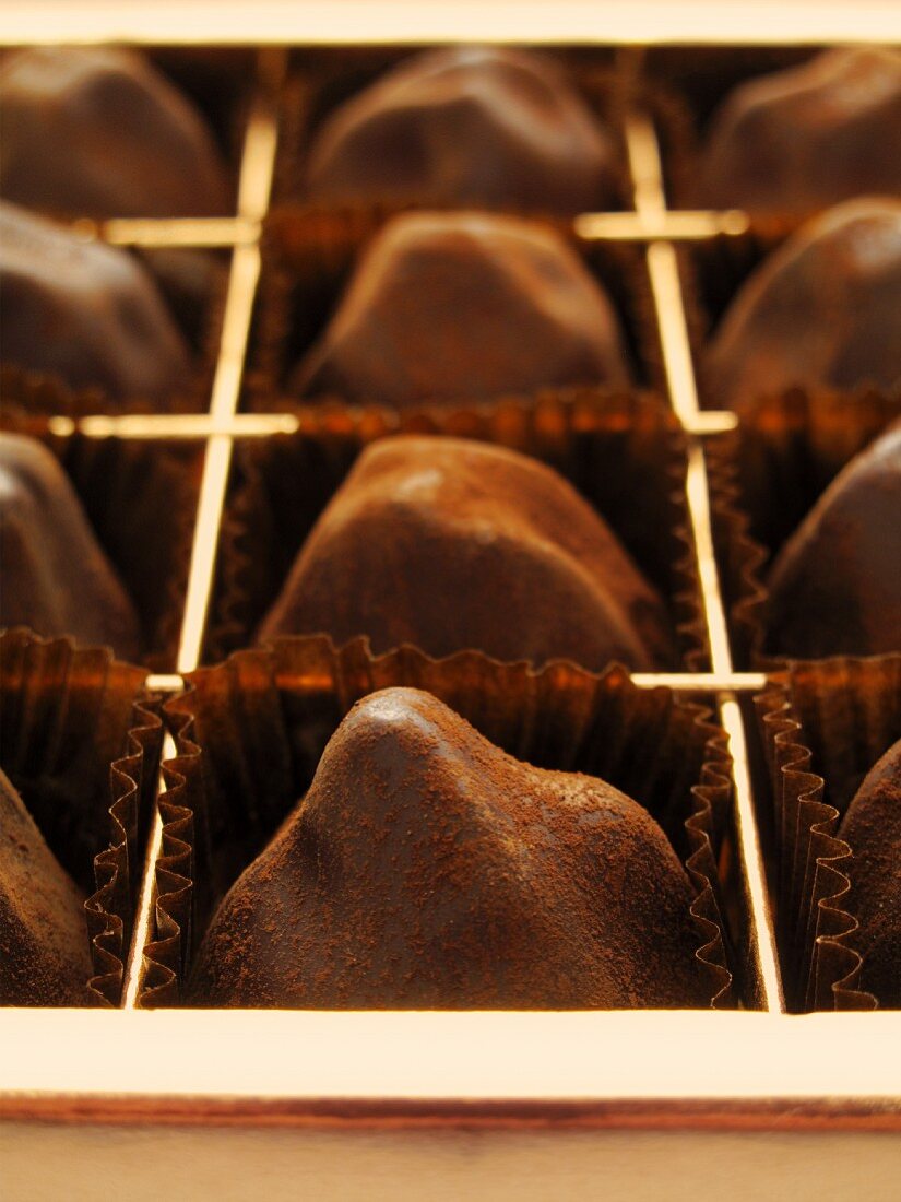 Chocolate truffles in a chocolate box (close-up)