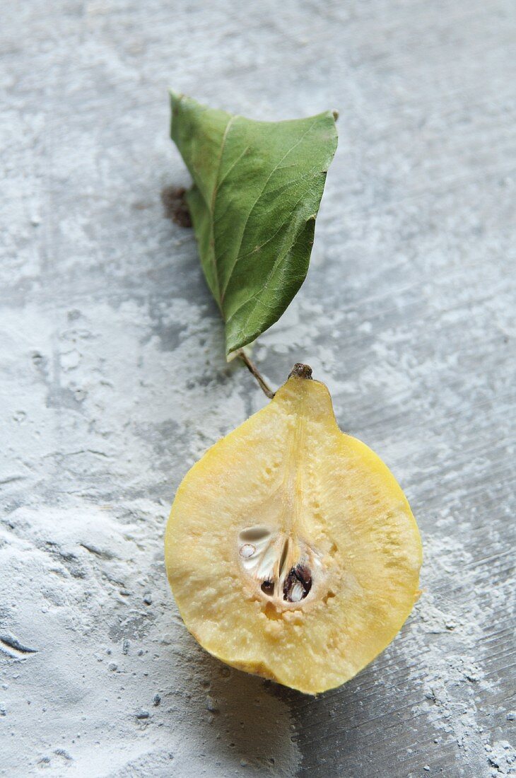 Half a quince with a leaf