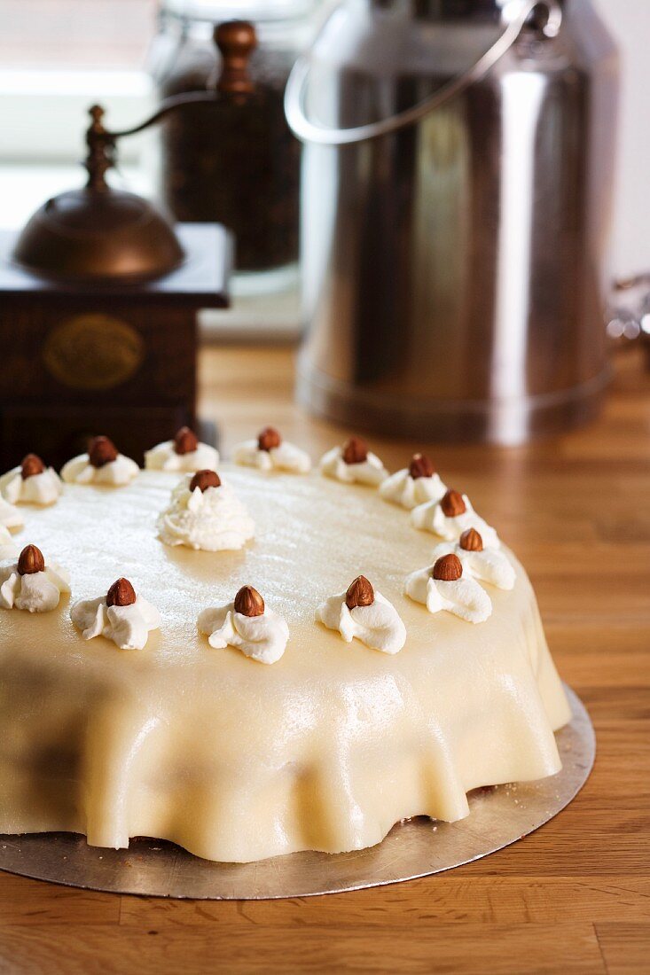 Nut cake, coffee grinder and milk pitcher