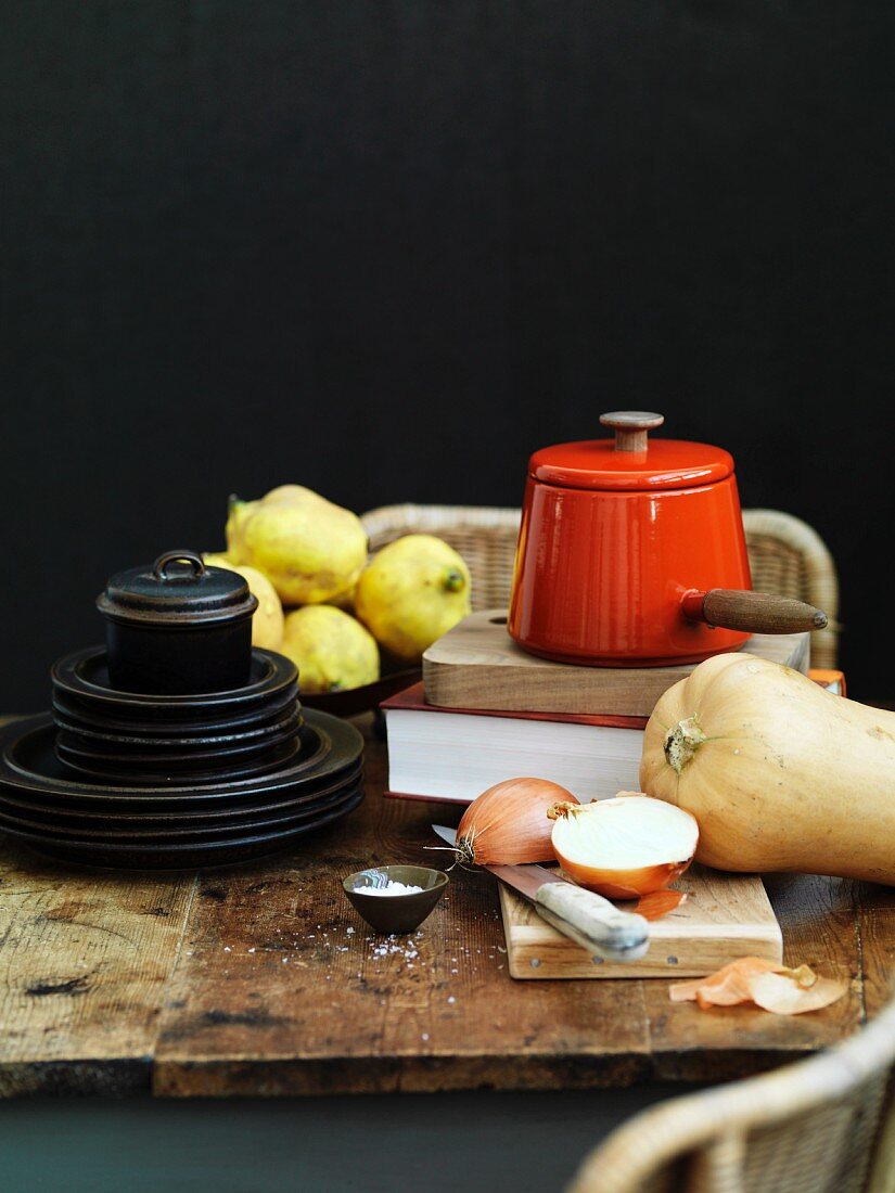 Still life with kitchen utensils, vegetables and quinces