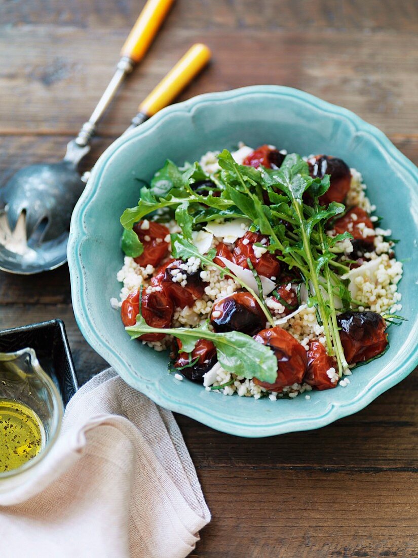 Couscous salad with dried tomatoes, olives and rocket