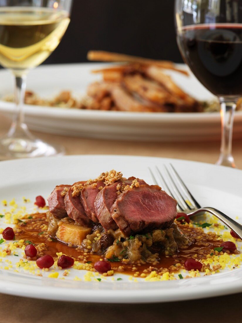 Roast saddle of lamb with cranberries and wine