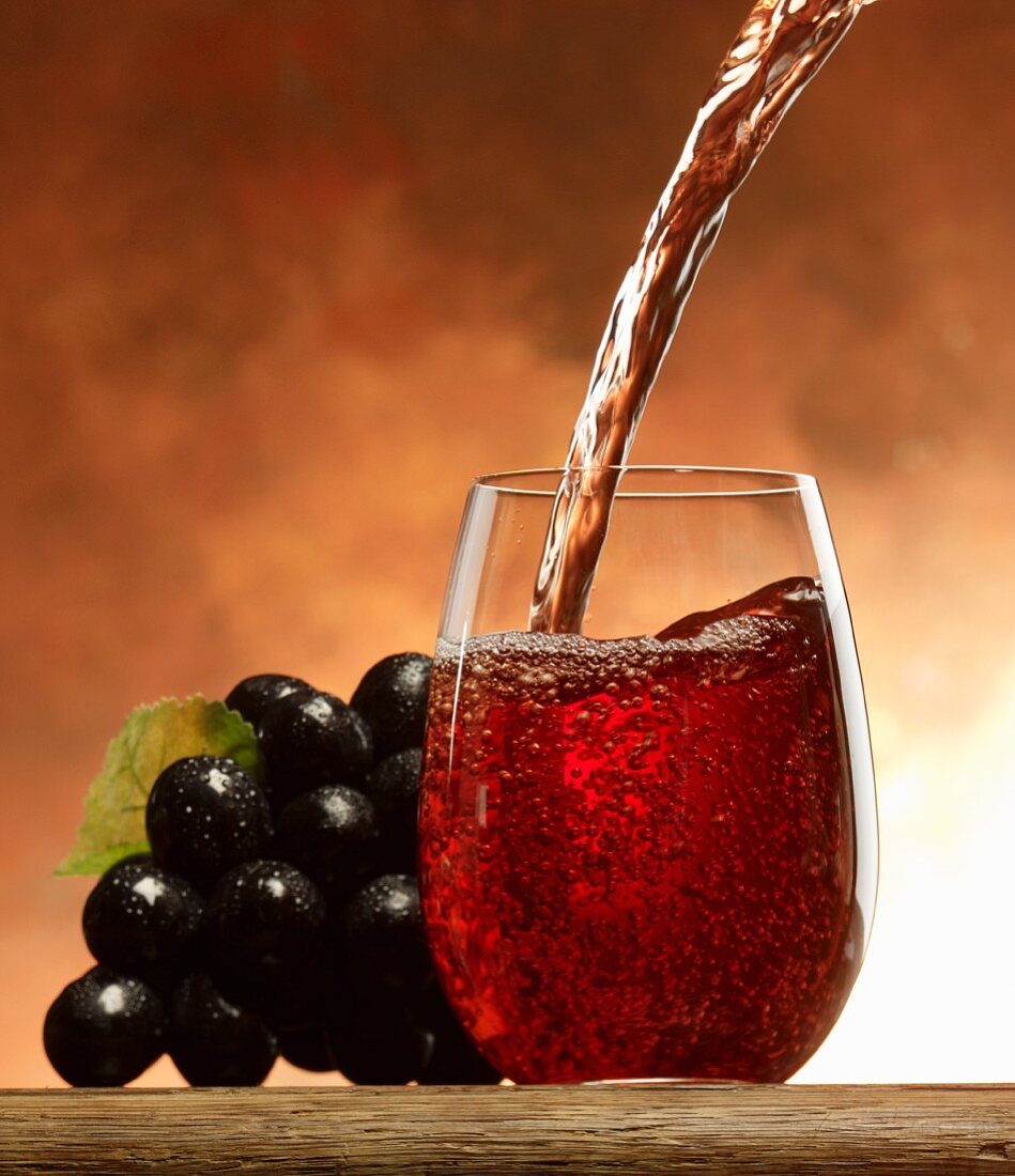 Pouring grape juice into a glass