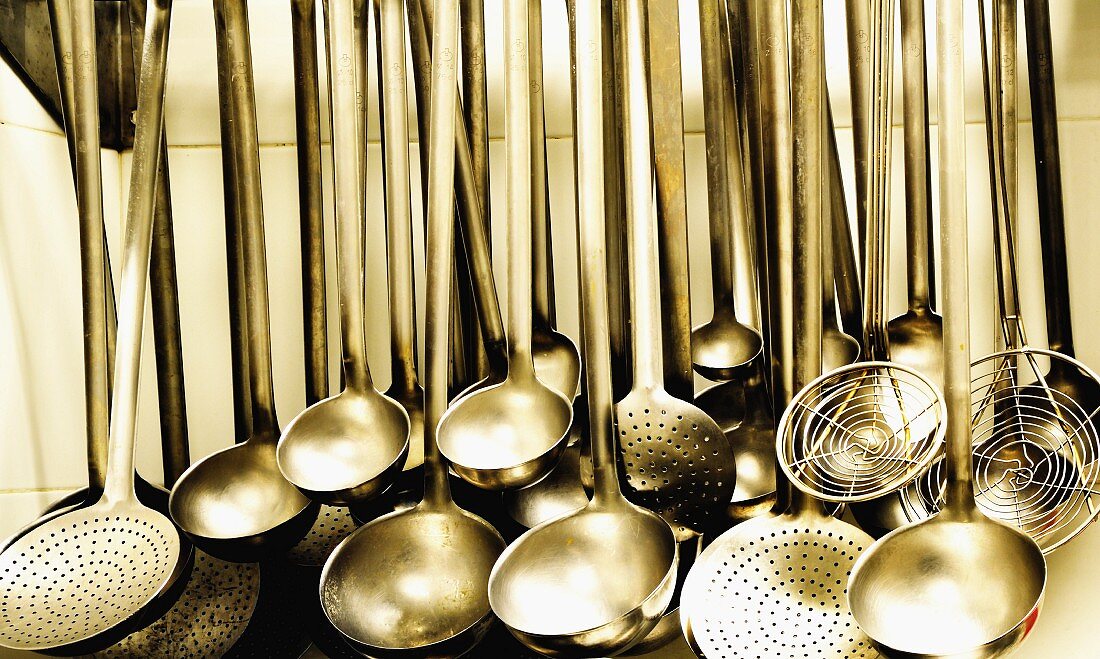 Ladles and strainer spoons in a large kitchen