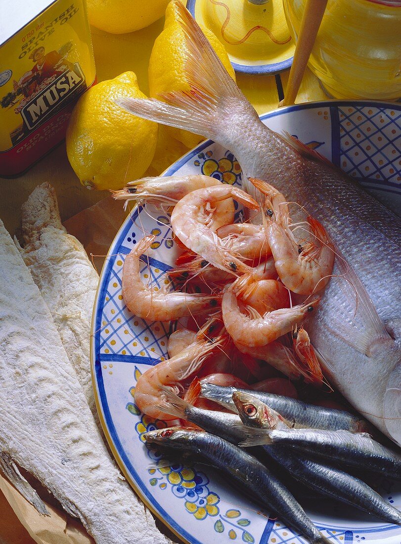 Assorted seafood still life with whole shrimp, sardines and fish coated with flour