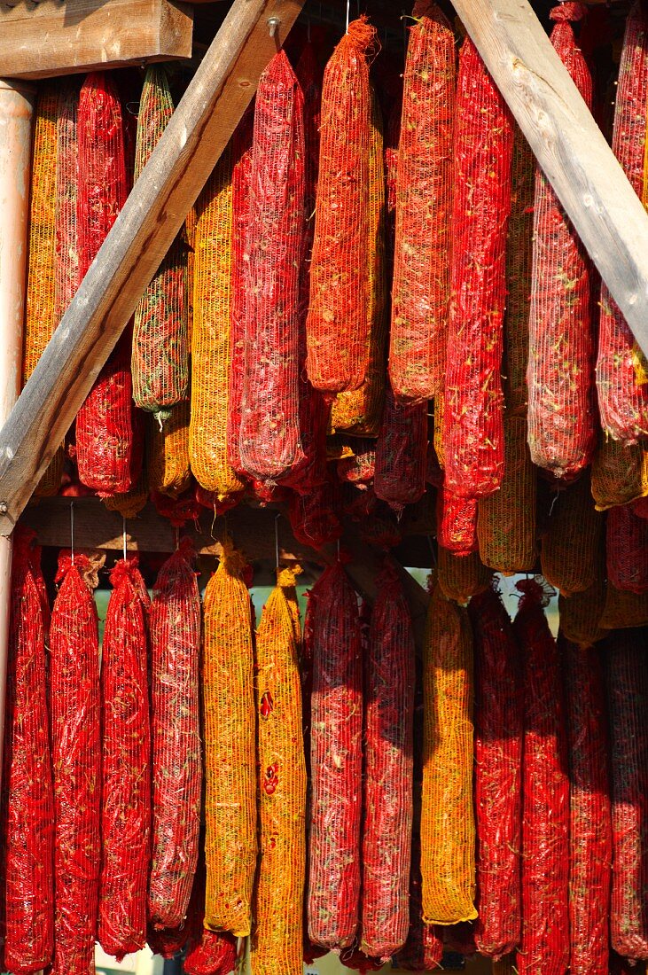 Chili peppers in mesh bags on a market stall