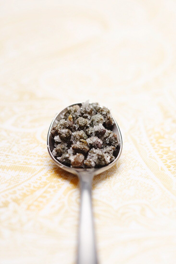 Spoonful of Capers with Sea Salt; White Background