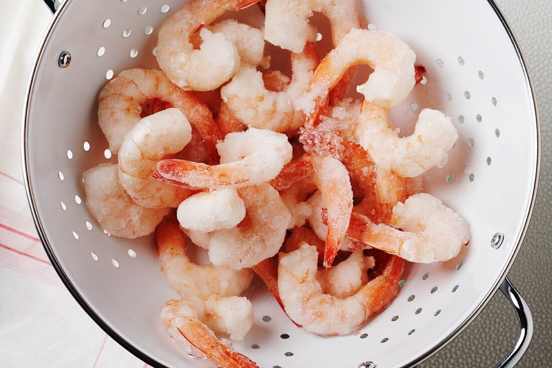 Precooked Frozen Shrimp in a Colander; From Above