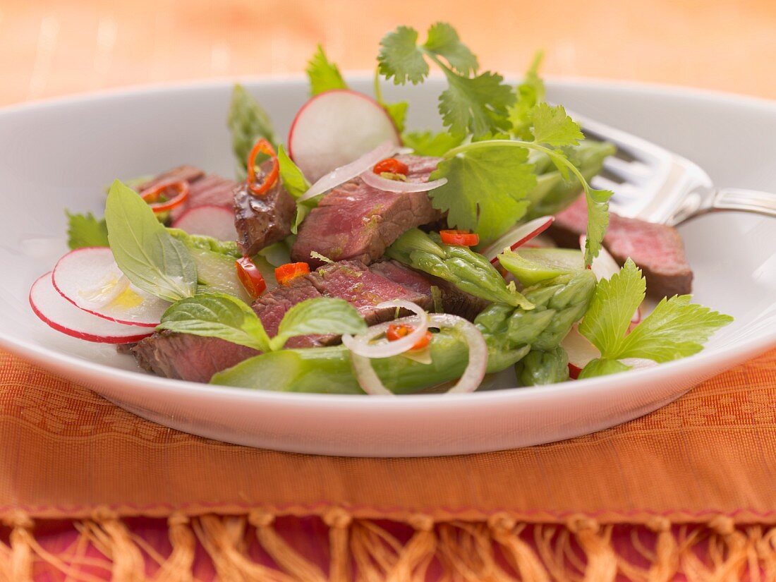 Beef salad with green asparagus and herbs