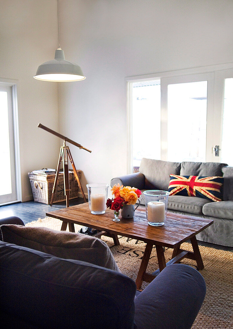 Living room with wooden table and telescope