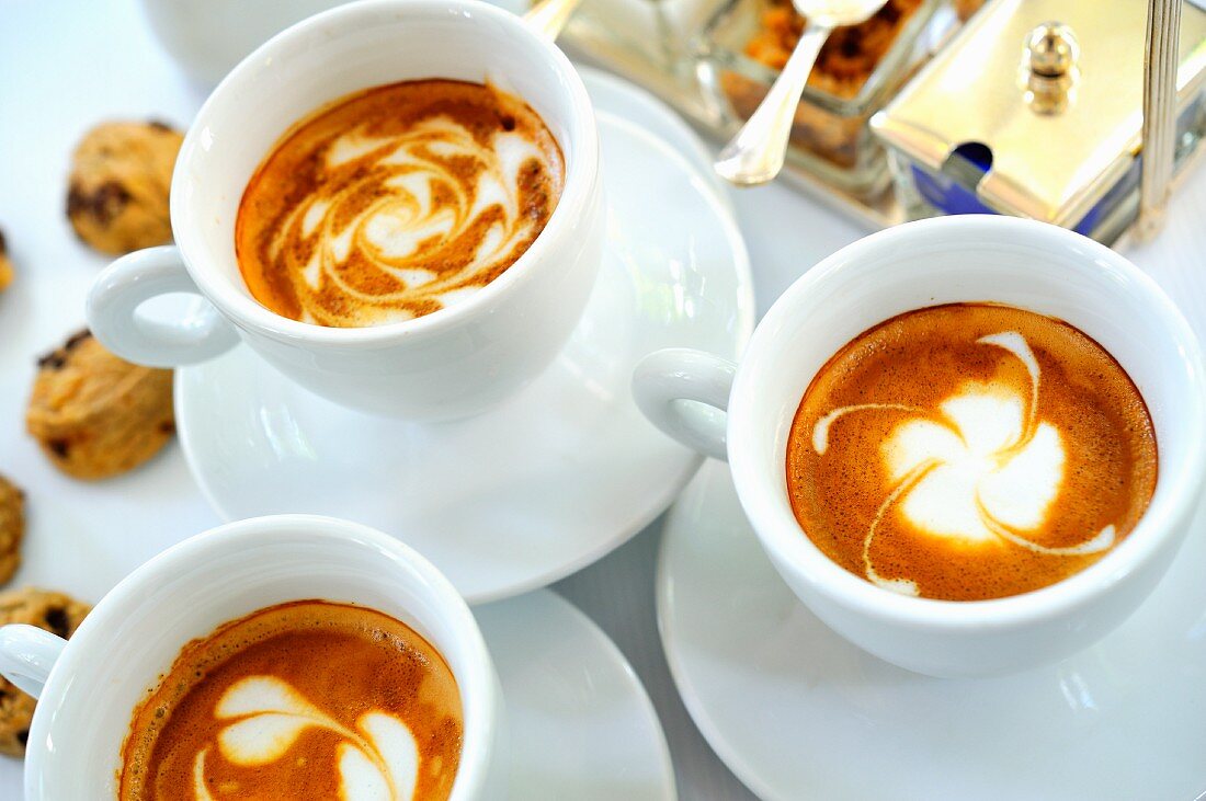 Cappuccinos and small chocolate Amaretti biscuits