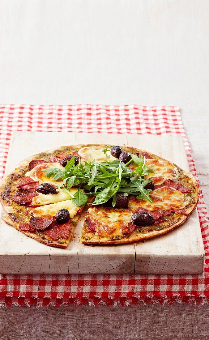 Salami pizza with olives and rocket