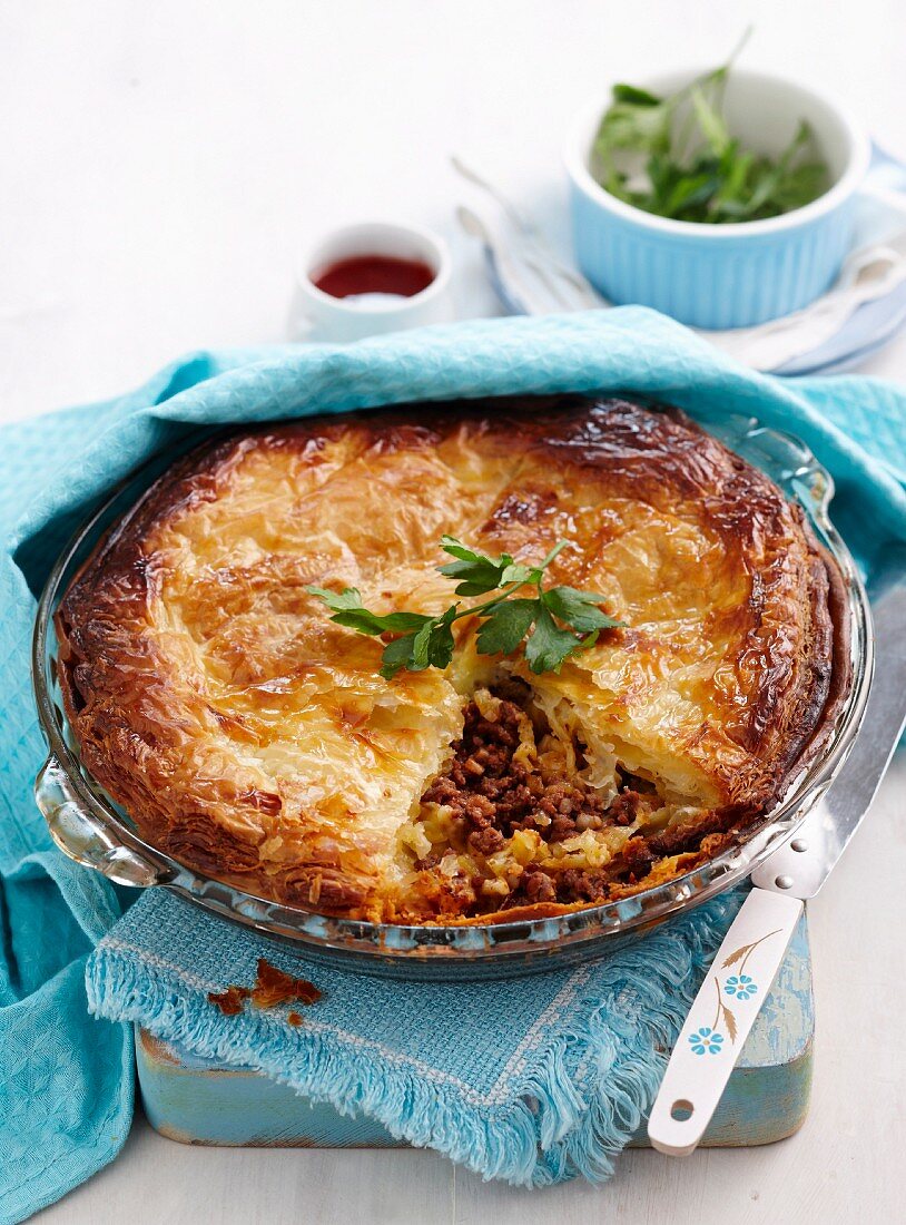 Ground beef and cheese pie in a glass pie pan