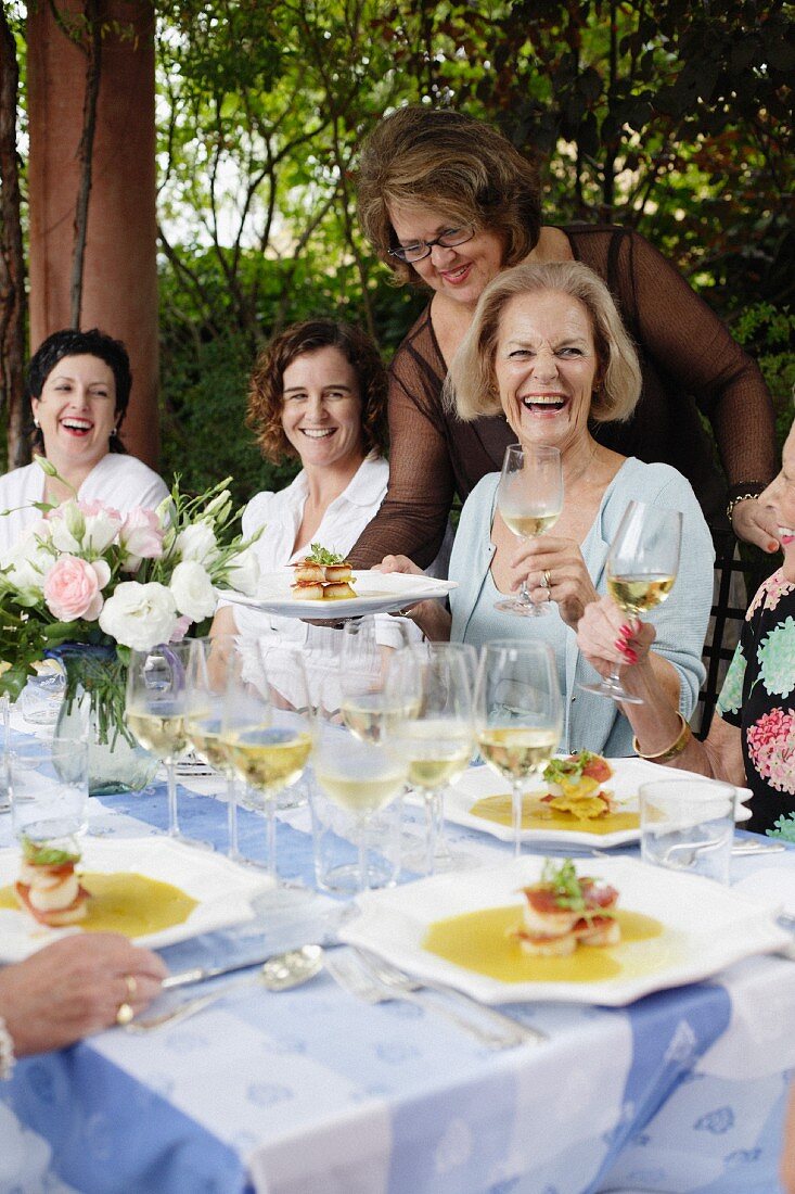 Women wine tasting in a garden