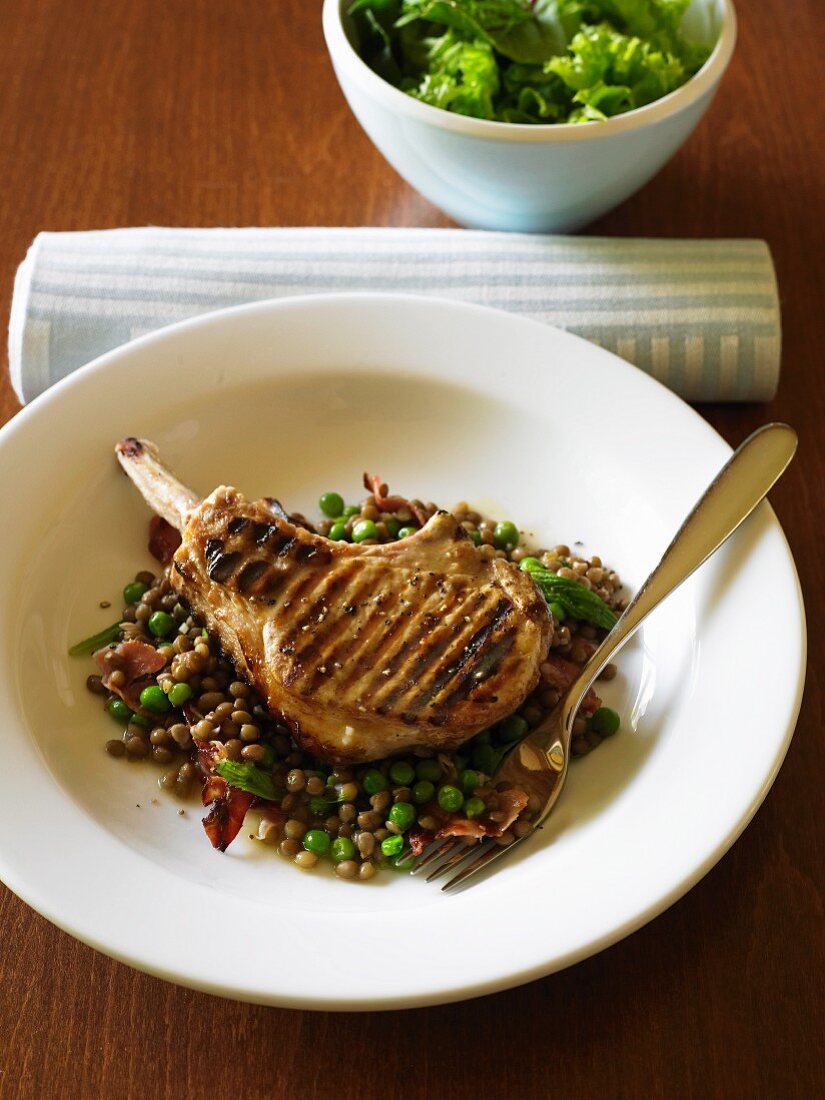 Pork chop on lentils with pancetta